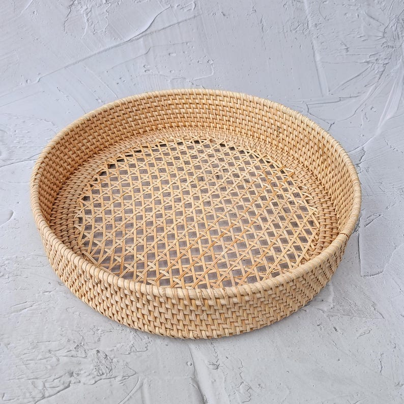 Natural round rattan tray with an open lattice webbing center